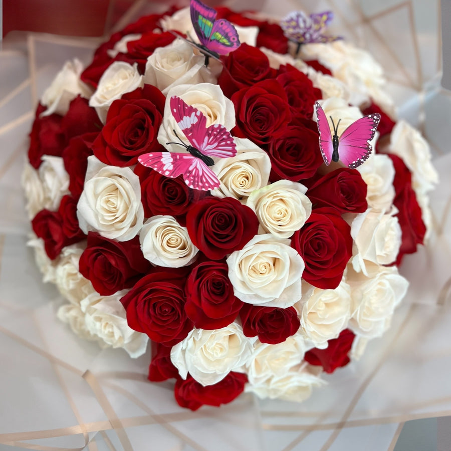 Man holding a bouquet of red, white, and pink roses perfect for Valentines Day